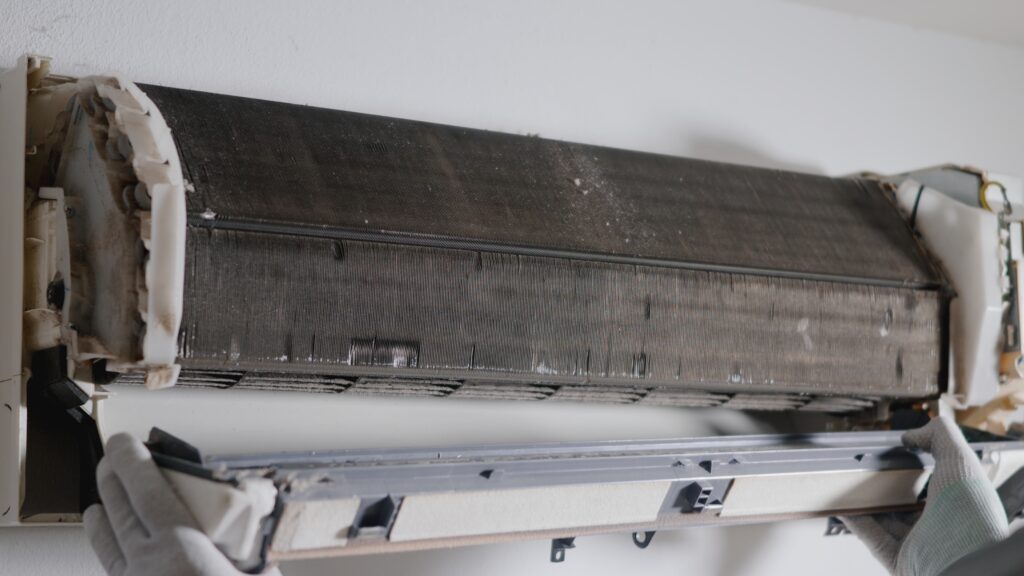 Technician checking and repairing an air conditioner